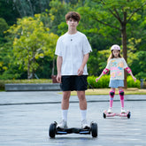 Two children on hoverboards in a park setting